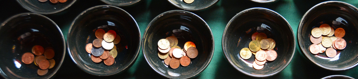 Mehrere Keramikschalen gefüllt mit Kleingeld
