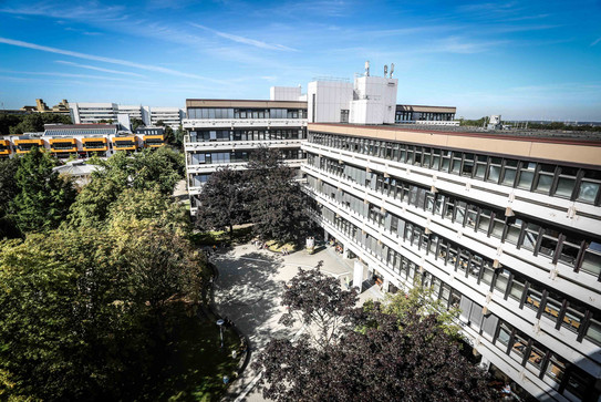 A long building surrounded by trees